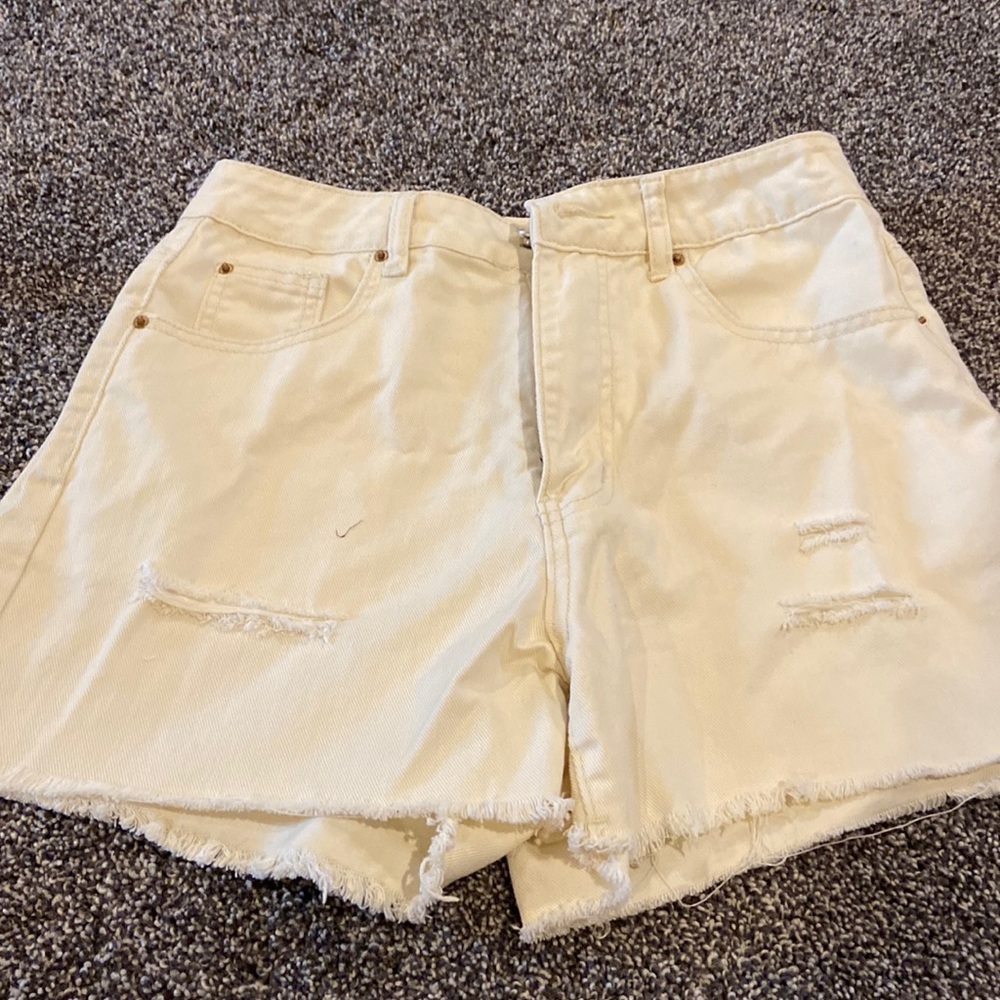 Women’s jean shorts with a few slits. SZ Medium. NEVER WORN